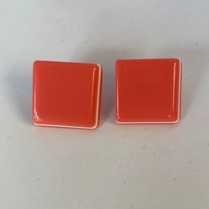 Z35 Plastic earrings that are peach and white in colored.